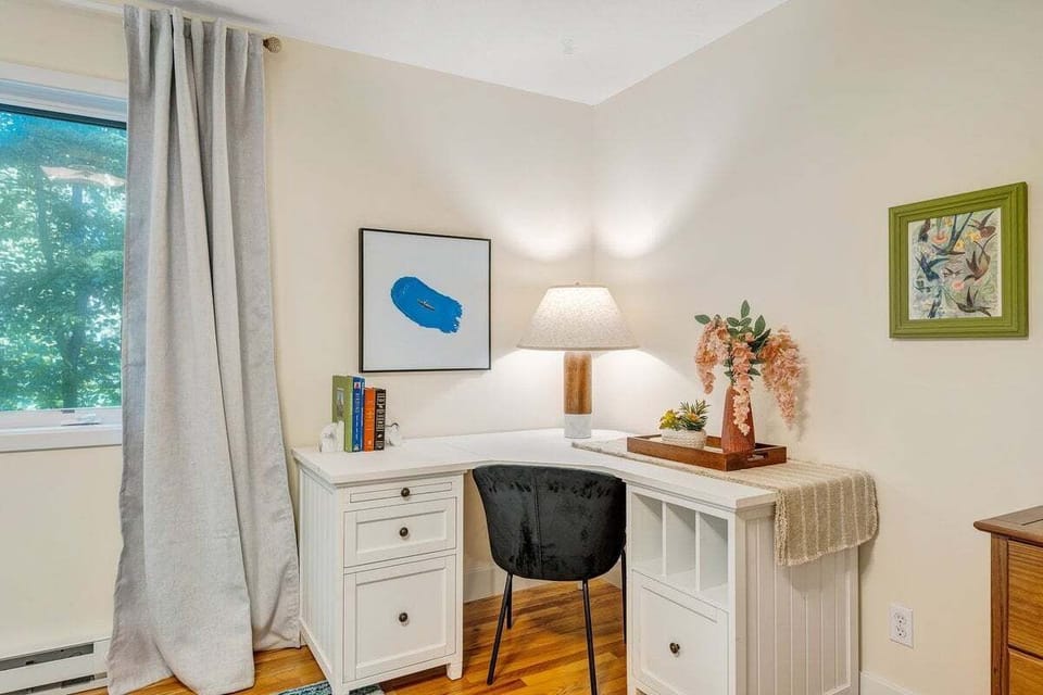 Designated workspace in mid-level king bedroom with view of the lake