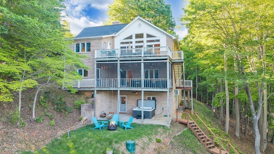 Lake side of house showing three stories with beautiful water views