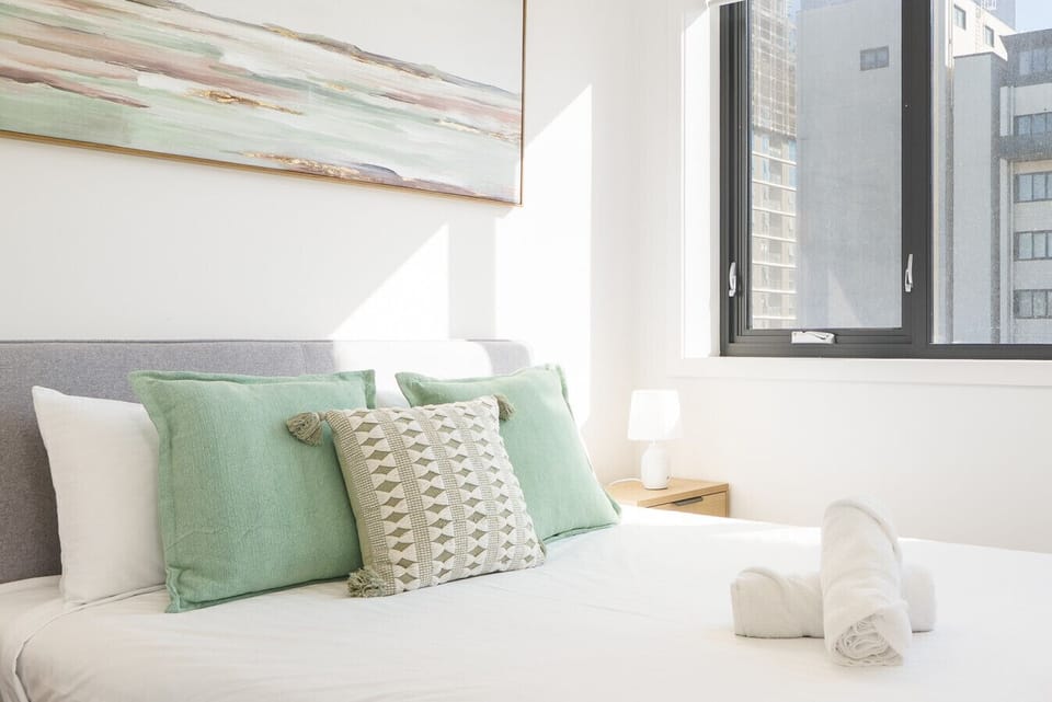 Bright and inviting bedroom with soft textures and a welcoming atmosphere.