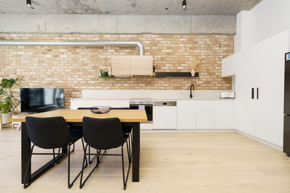 Spacious open-plan layout blending dining and kitchen seamlessly, offering comfort and functionality.