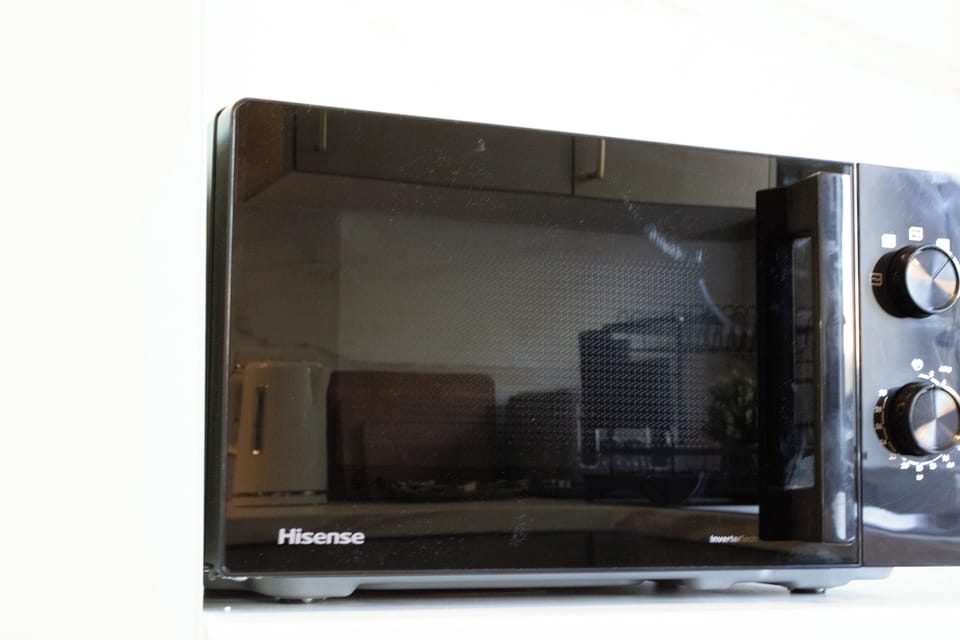 A fully equipped kitchen designed for convenience, featuring modern appliances and everything needed for home cooking.