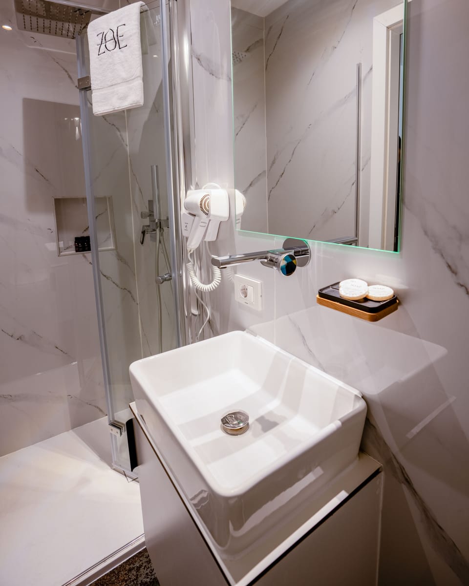 Family Quadruple Room, City View | Bathroom | Shower, hair dryer, slippers, towels