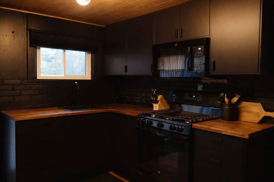Taking a risk with a bold, black kitchen, we love how it came out with lots of storage and everything you need to cook meals here.