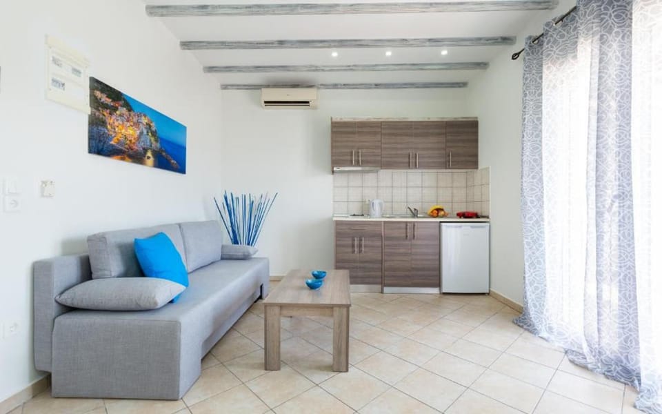 Living space with wide balcony doors that open fully, bringing in natural light and allowing easy access to the outdoor seating area.
