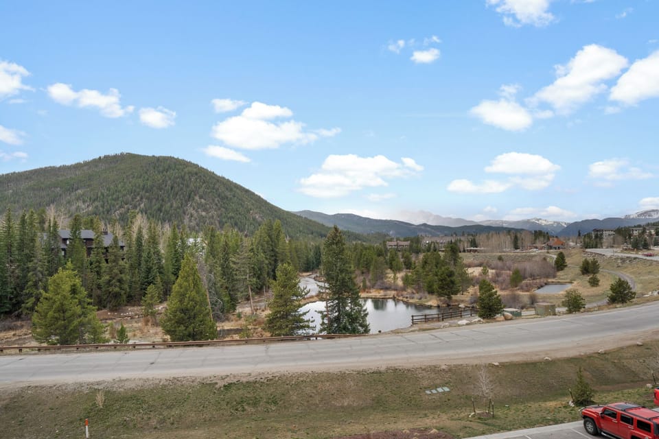 The property sits in a scenic mountain community with forested slopes, a tranquil pond, and wide-open Colorado skies—a peaceful setting for your mountain getaway.