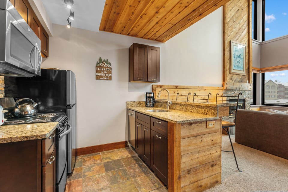 Your fully equipped kitchen blends rustic mountain charm with modern convenience—granite counters, warm wood accents, and everything you need to whip up meals after a day exploring nearby peaks.