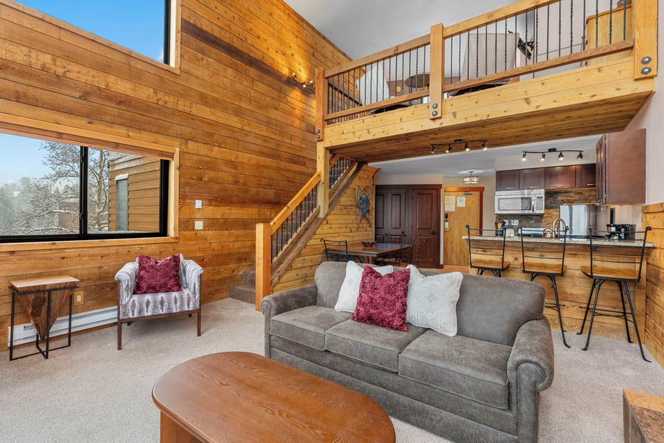 Relax in your sunlit living area with soaring ceilings and charming wood walls. The lofted space adds adventure, while the open kitchen invites you to cook and gather with loved ones.