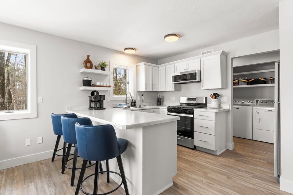 Fully equipped kitchen with breakfast bar seating for three