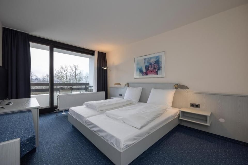 Unwind in crisp linens and wake to balcony views.