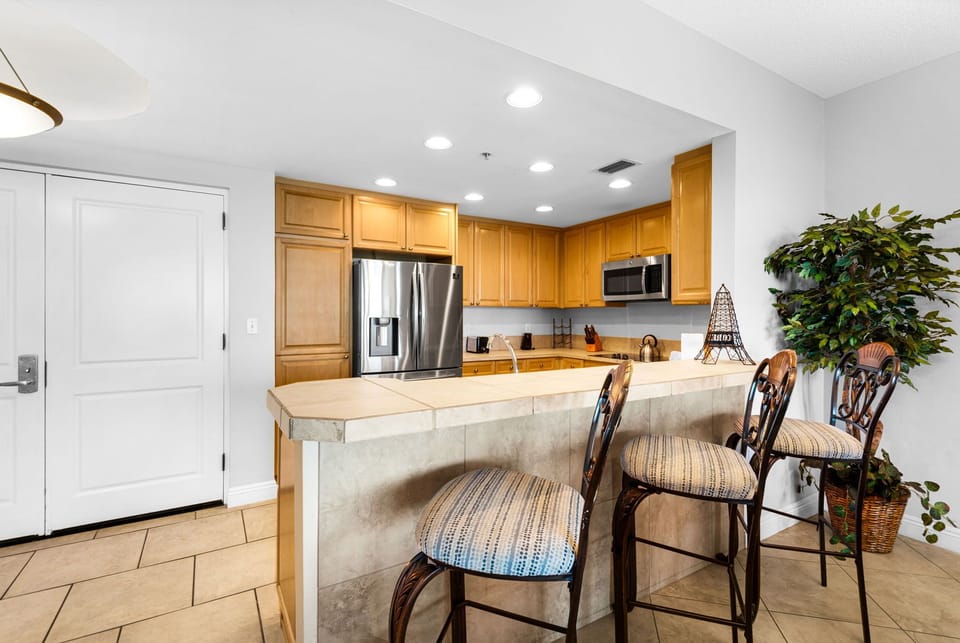 Convenient breakfast bar with additional seating perfect for casual dining, coffee, or gathering with family and friends.
