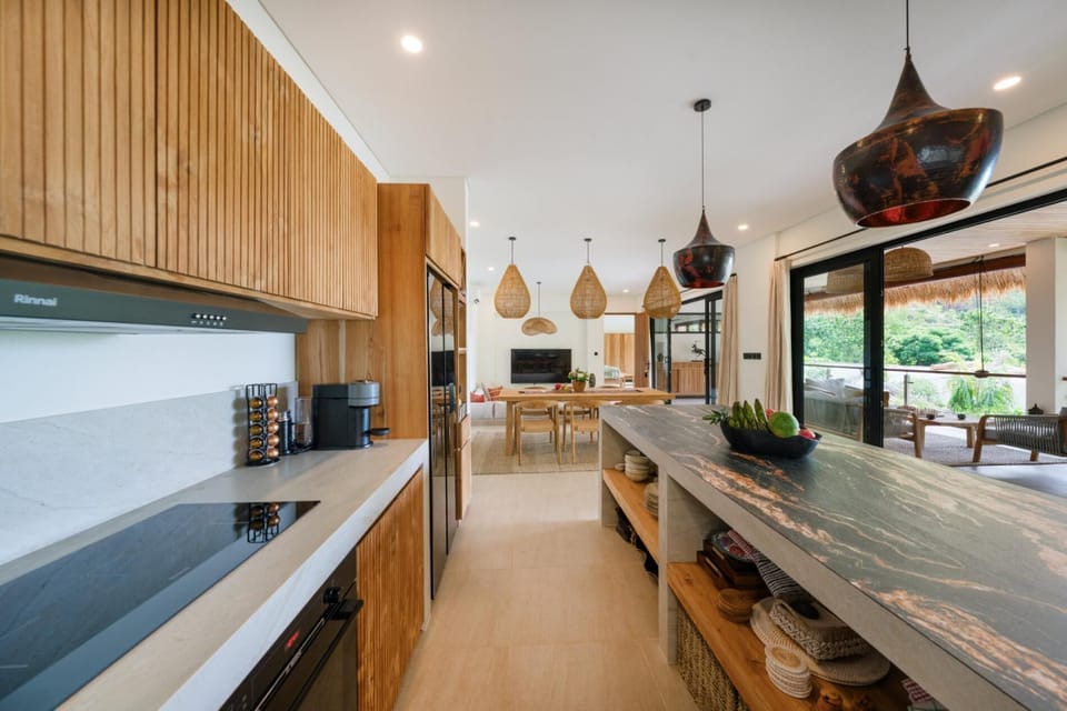Open-plan kitchen and upper-floor living spaces with access to the outdoor balcony