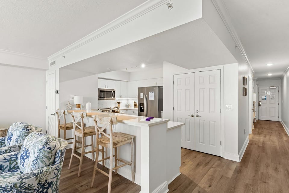There is a dining table, perfect for enjoying a meal or playing a game, as well as additional breakfast bar seating.