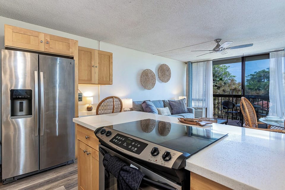 Natural light streams through sliding doors to your private lanai overlooking lush tropical views.