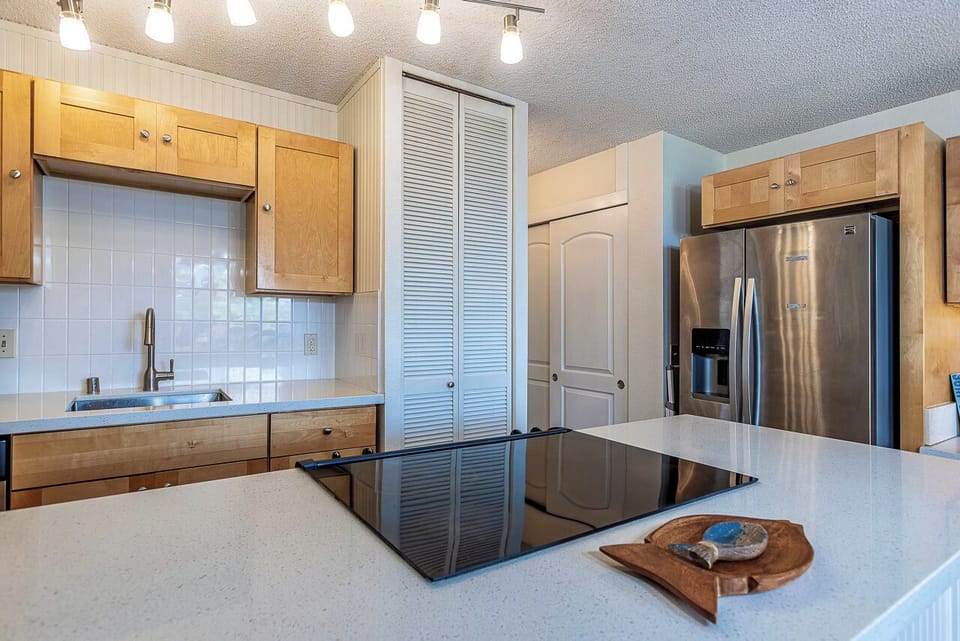 Your kitchen awaits with modern appliances and stylish track lighting for delightful meal preparation.