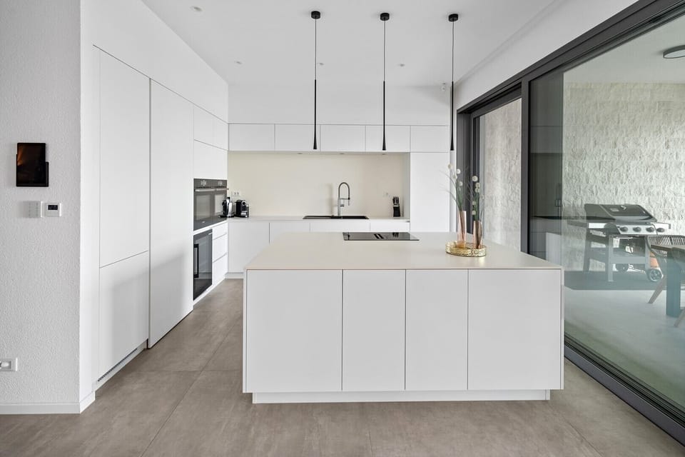 Two ovens (one is a combo with a microwave), a wine cooler, a fridge, and a dishwasher.
