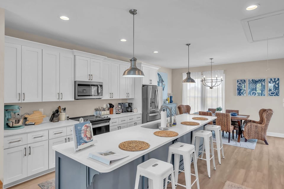 Gather around your spacious island for breakfast prep or casual dining, with modern appliances and coastal charm throughout.