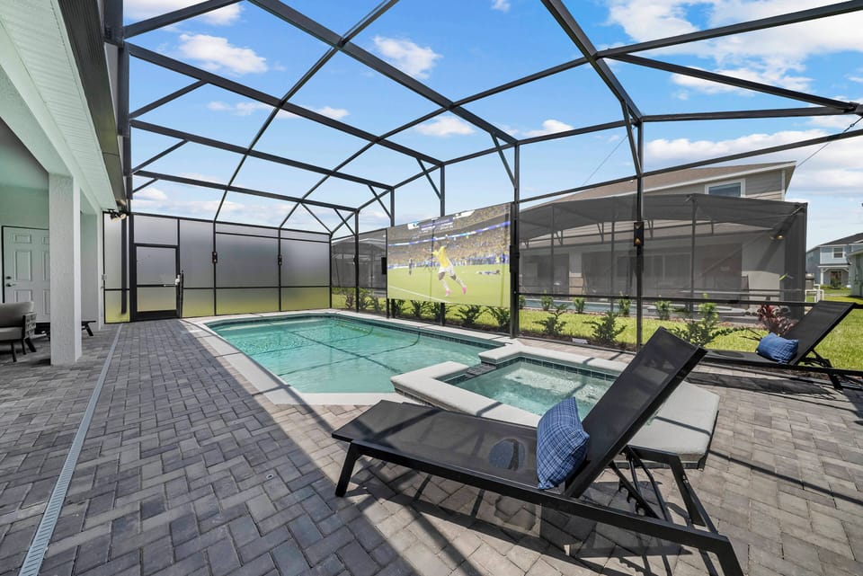 Step outside to enjoy your private oasis, featuring a sparkling pool and relaxing spa. The inviting loungers and stylish paver stones create a perfect backdrop for sunbathing, while the screened enclosure offers a peaceful escape.