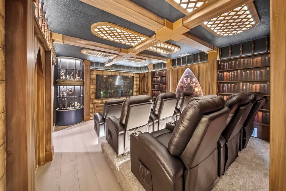 Experience a cozy home theater designed for your comfort, with plush leather recliners for the best viewing. The warm wooden accents and soft lighting set the perfect ambiance for unforgettable movie nights or gaming marathons.