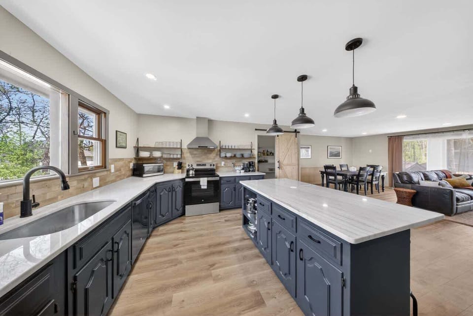 Oversized marble island opens to the dining area and family room
