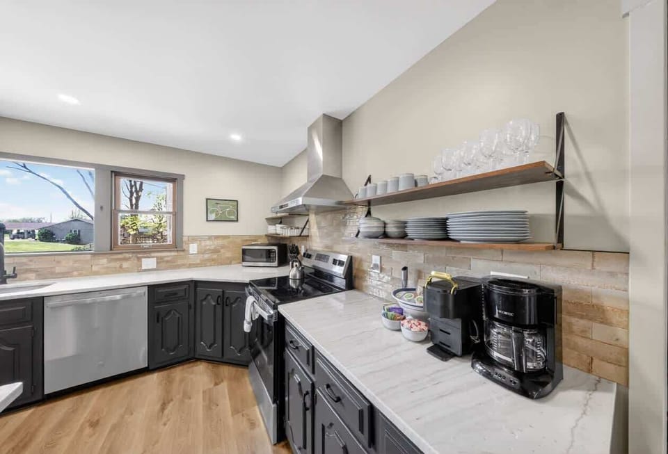Open shelving with full dishware, glassware, coffee bar, and Nespresso