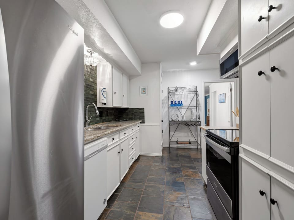 Your fully equipped kitchen awaits with granite counters, modern appliances, and ample cabinet space for culinary adventures.