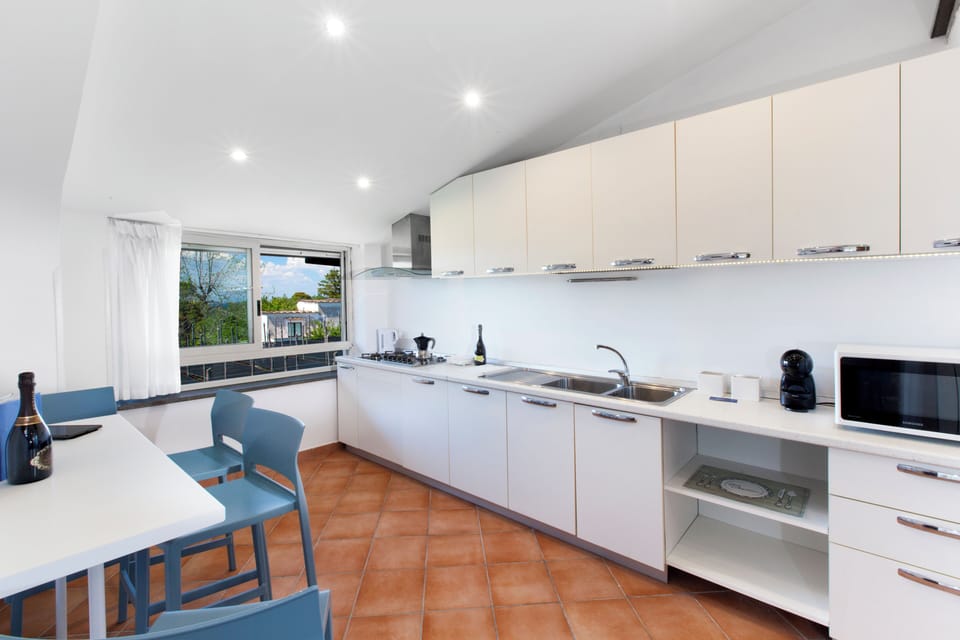 Penthouse, Partial Sea View | Private kitchen | Fridge, microwave, stovetop, espresso maker