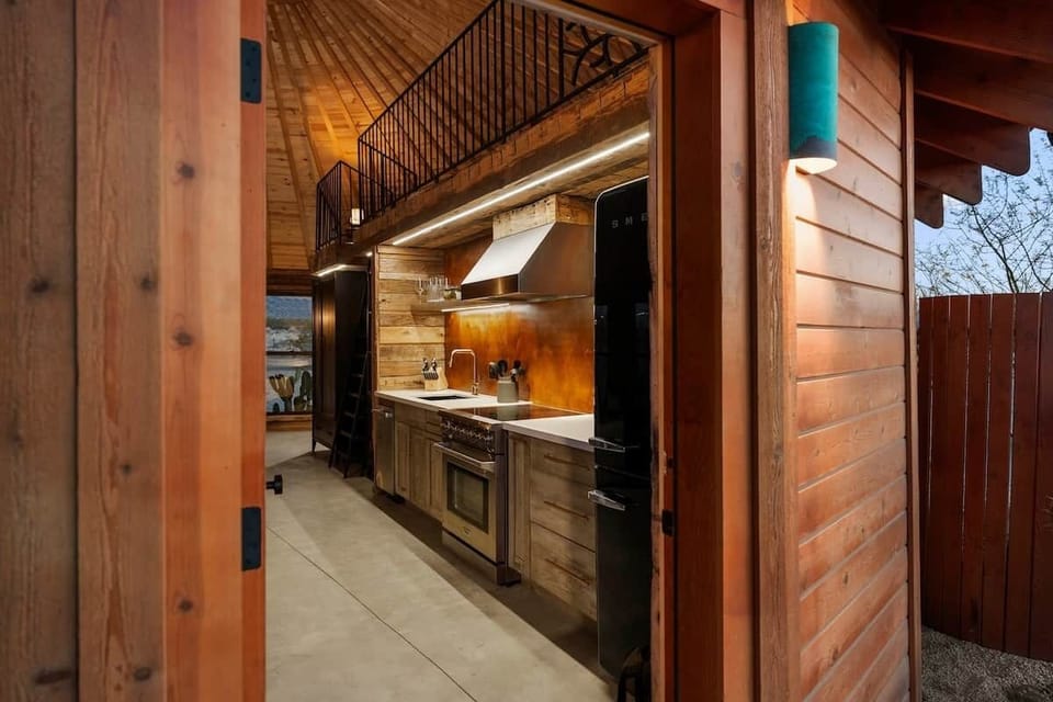 Cross the threshold into the culinary suite — patina steel, a pro range, and the loft's steel
