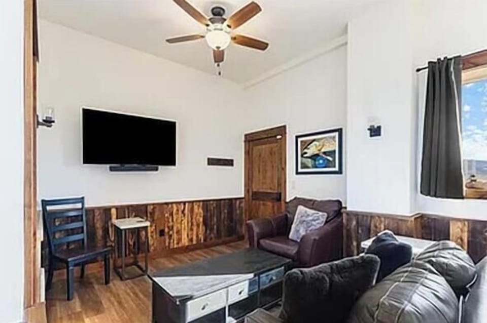 Living room area with smart tv and leather sofa sleeper.