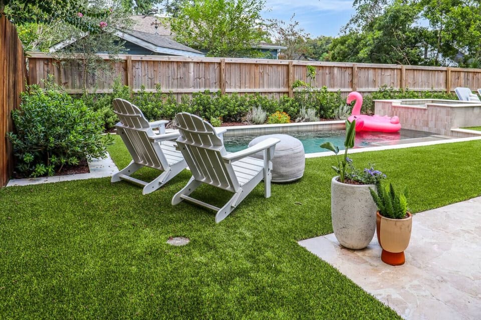 Your own fenced backyard oasis with a heated pool, hot tub, and plenty of space to lounge in the Charleston sunshine - yes, that flamingo float stays