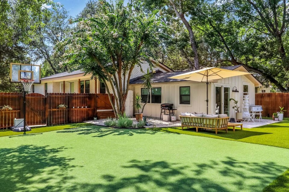 Your private backyard oasis with room to shoot hoops, lounge under mature shade trees, or gather around the fire pit for evening drinks