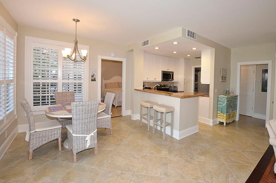 Unwind in your open-concept kitchen and dining space, where coastal charm meets modern convenience for easy meal prep and casual gatherings.