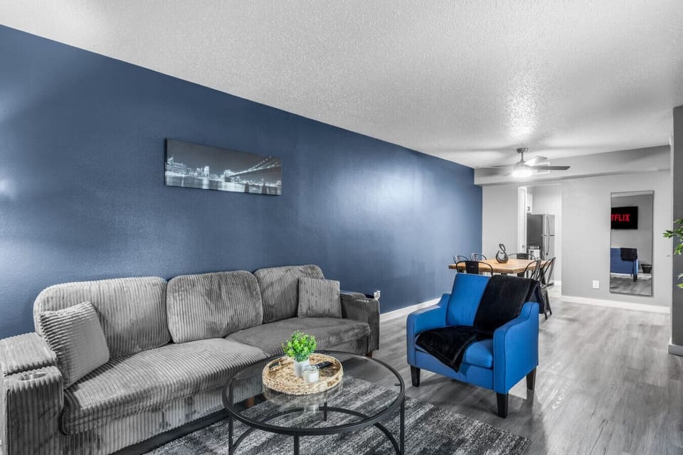 Spacious and inviting living area with comfortable seating and a smart TV, perfect for relaxing after exploring Arlington or attending events at AT&T Stadium.