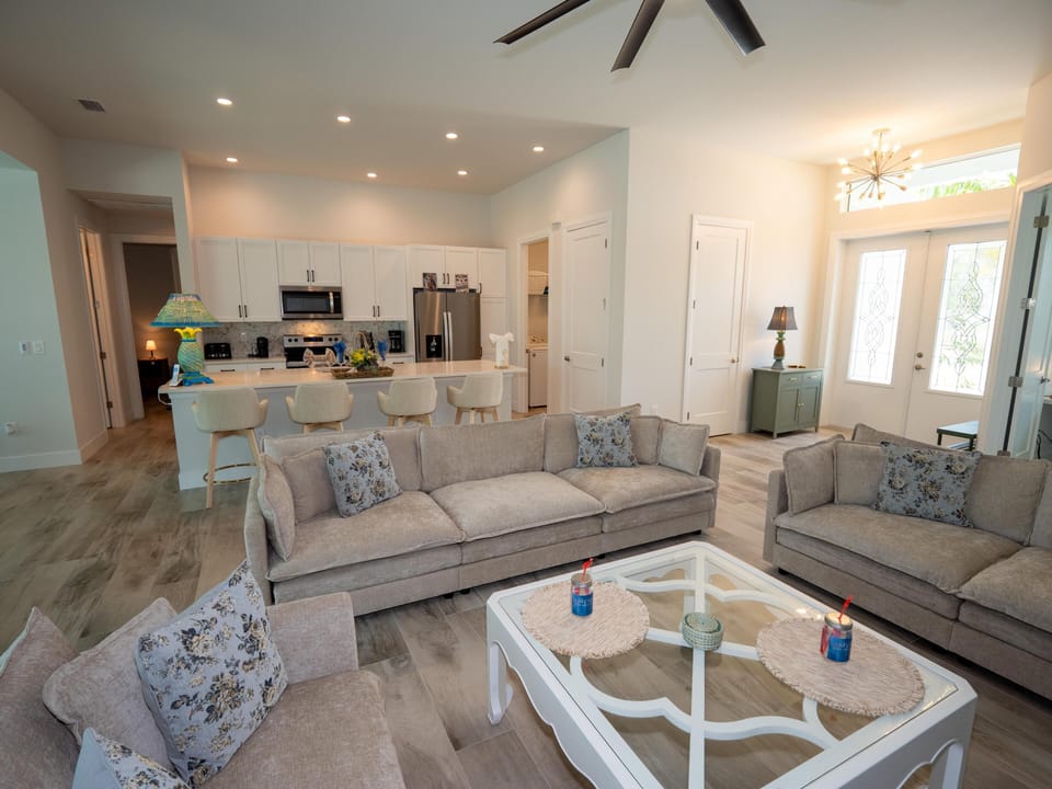Spacious living room with cozy seating and modern kitchen access
