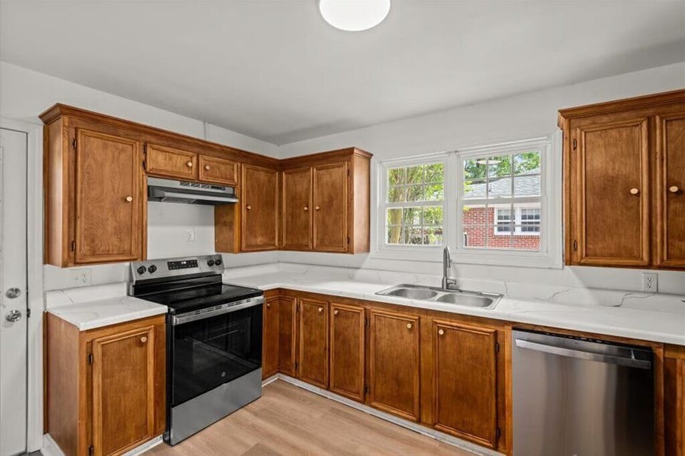 Fully stocked kitchen with stainless steel appliances.