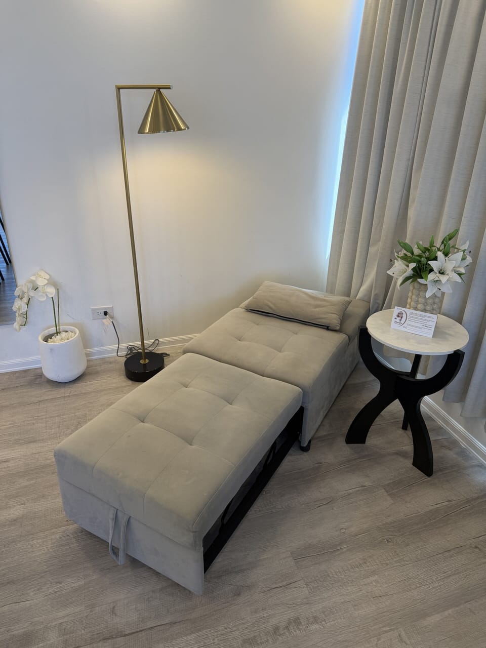 Cozy modern lounge nook with chaise seating and elegant ambient lighting