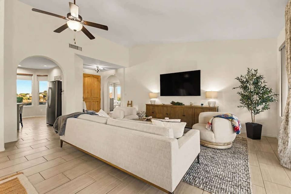 Bright and spacious living room with comfortable seating, perfect for relaxing or movie nights.