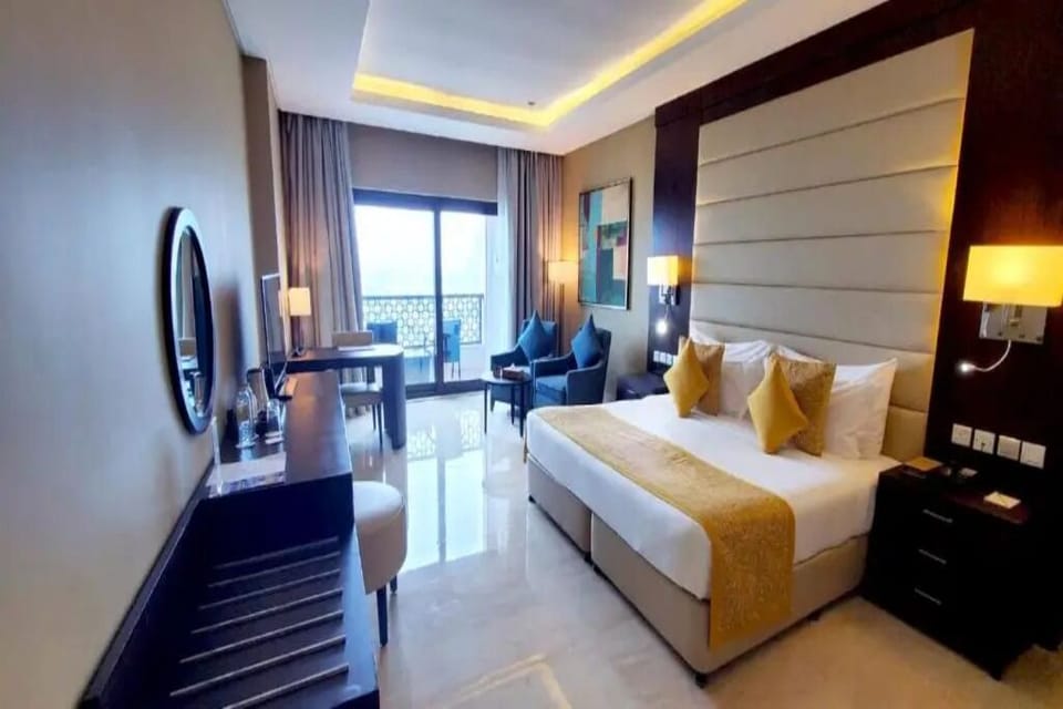 Unwind in a bright, elegant bedroom with balcony views.
