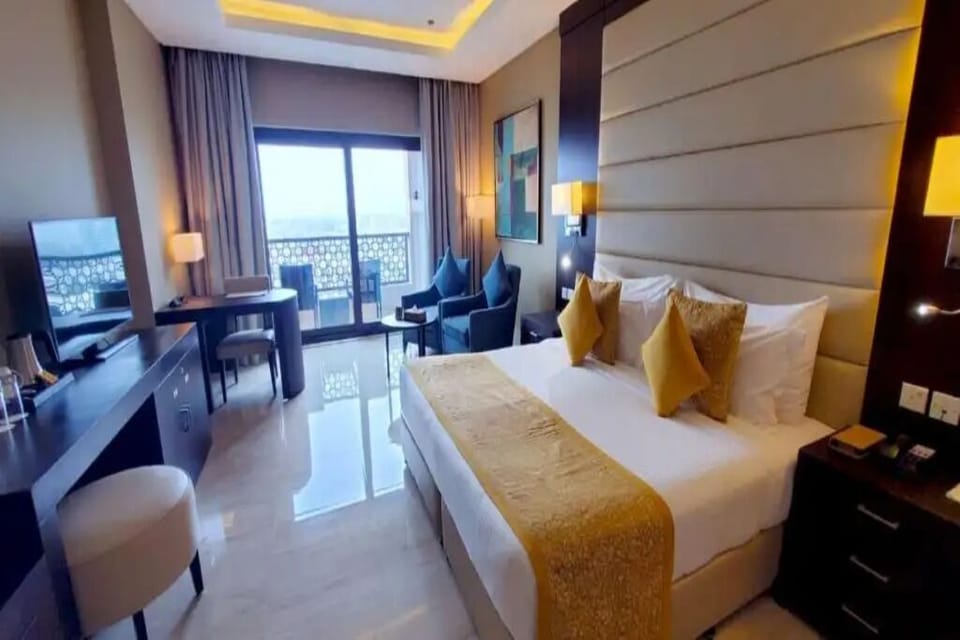 Savor morning light from bed with a private balcony beyond.