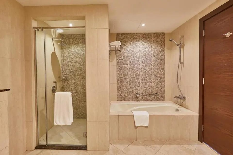 Soak or shower in a bright bath space with fresh towels.