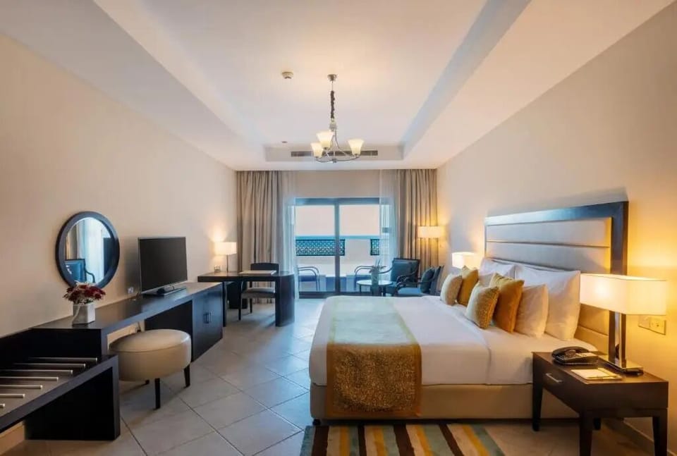 Unwind in a spacious room with balcony light and calm.