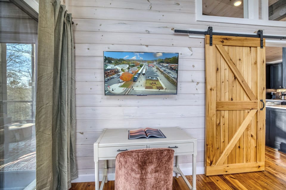 The perfect blend of work and play! This dedicated workspace in the primary suite features a sleek desk and a wall-mounted Smart TV—ideal for a quiet Zoom call or streaming your favorite show.