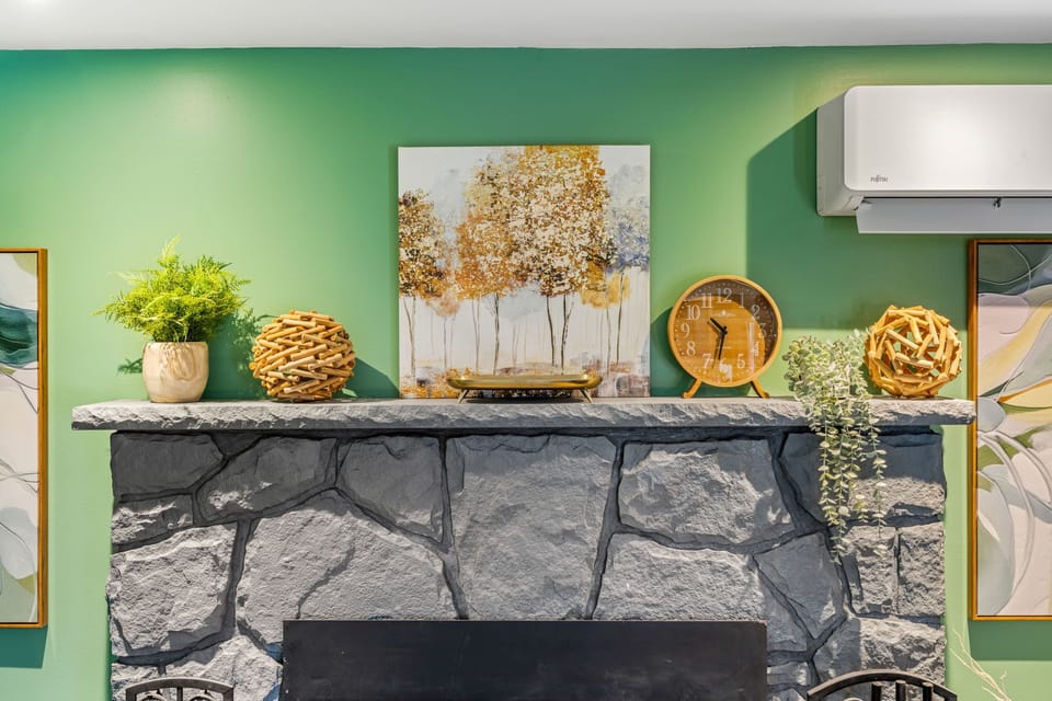 Decorative stone fireplace mantel with warm modern accents.