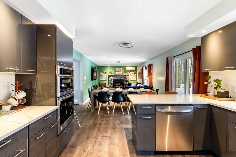 Open kitchen with island, dining area, and cozy living room.