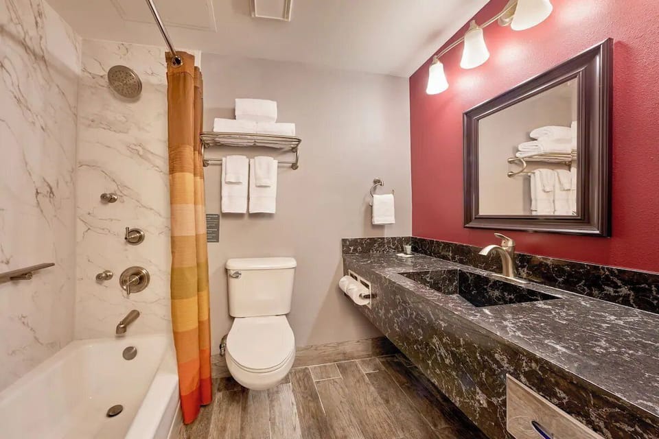 Refresh with a spotless bath, plush towels, and bright vanity lights.