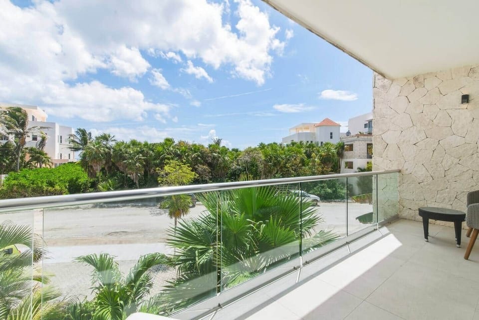 Relax on your private balcony just off the living room and bedroom, featuring comfortable outdoor furniture and a partial view of the Akumal sea—perfect for unwinding and enjoying the fresh ocean breeze.