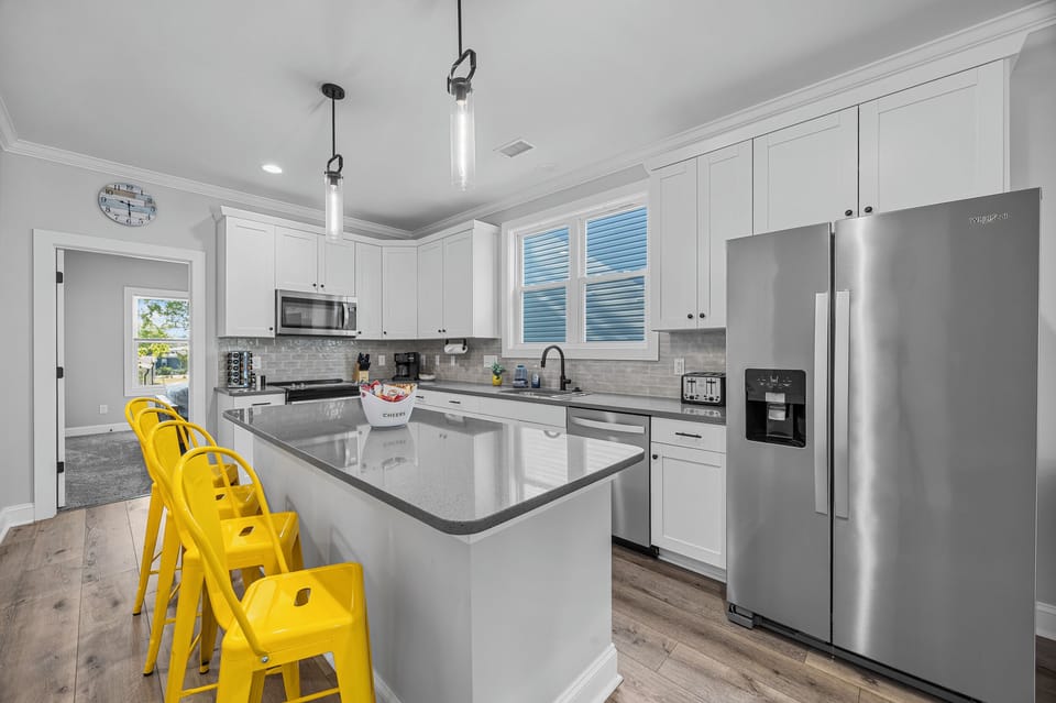 Modern kitchen fully stocked with cookware, coffee essentials, Keurig, and everything needed for cooking meals and entertaining during your stay.