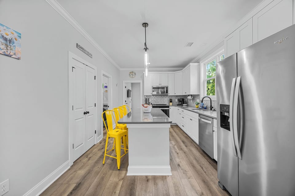 Modern kitchen fully stocked with cookware, coffee essentials, Keurig, and everything needed for cooking meals and entertaining during your stay.