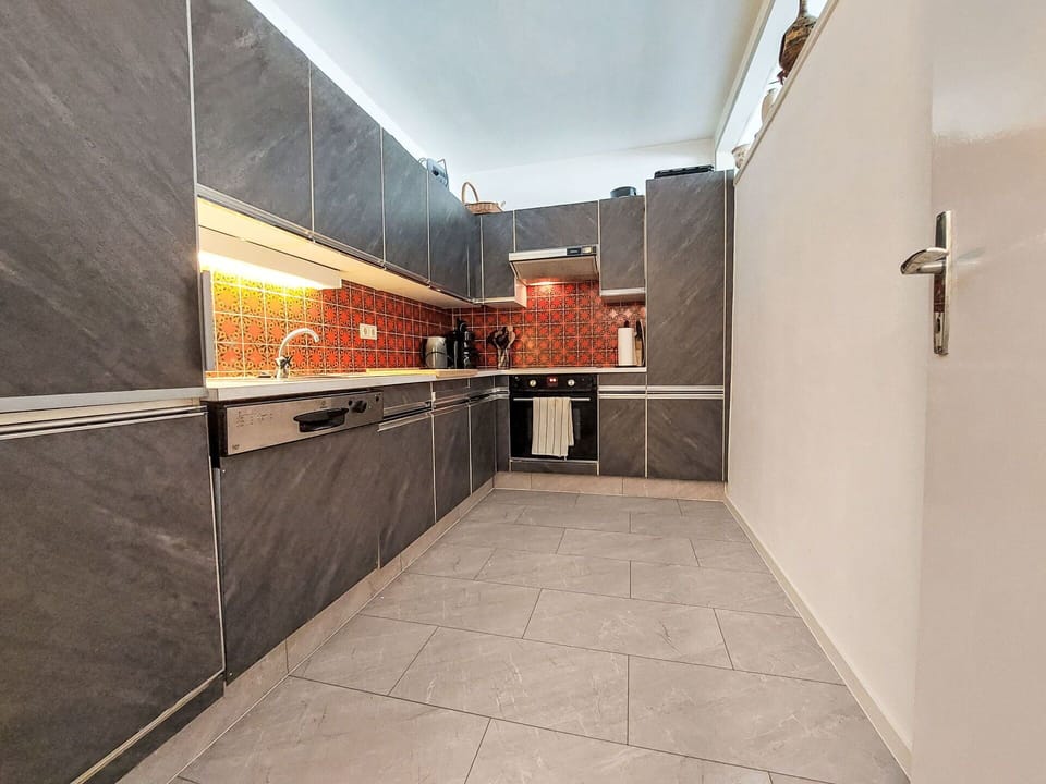 Flooring, Kitchen, Wood, Floor, Countertop, Major Appliance, Ceiling, Interior Design, Lighting, Kitchen Appliance