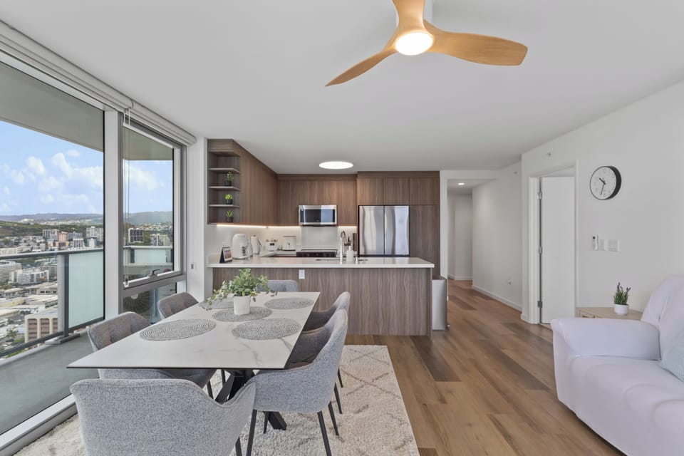 Bright modern dining space with stunning city views and sleek kitchen