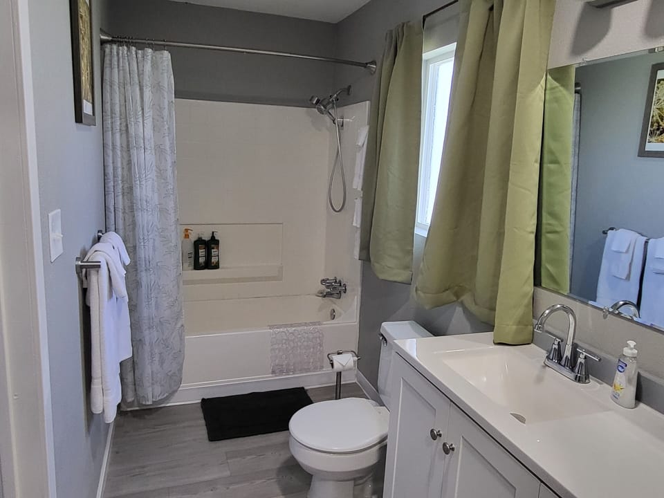 full bathroom with tub and shower plus amenities